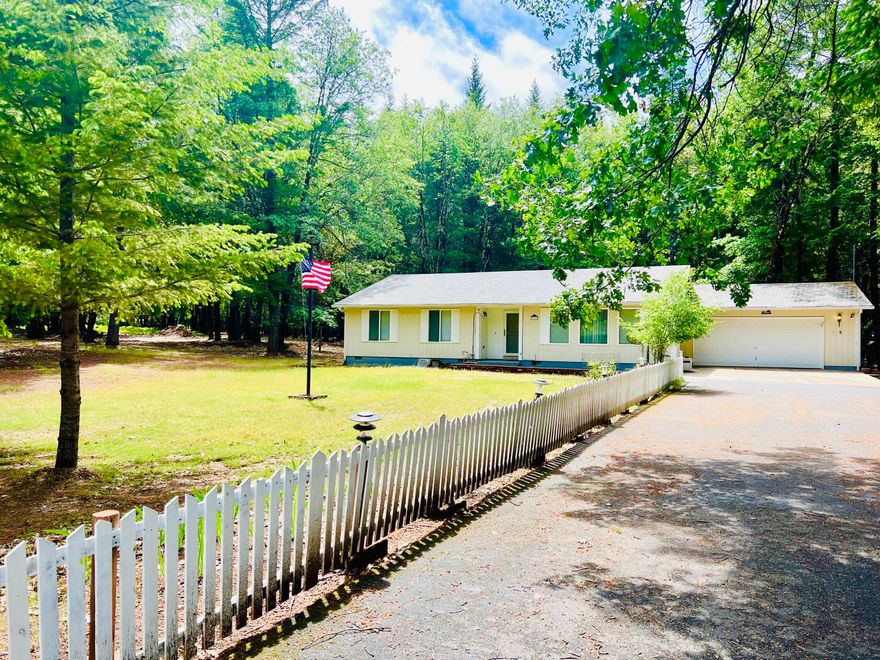 This is a beautiful 1704 sq ft 3 bed 2 Bath  home with attached 2 car garage and 3 bay detached garage in Serene neighborhood on 5 acres!
Beautiful hardwood floors and kitchen with granite counter tops were added 6 years ago. Large primary bedroom with bathroom. linen closet in hall, attic fan and a closed in  porch! Circle drive. Completely fenced except the two entrances to driveway.

The home is well cared for and  boast a new Kohler propane Generator with a 500 gal propane tank!  Generator is completely wired to all of the property. ( If you lose power, your generator turns on )

This neighborhood is so quiet and wild life abounds! The flat usable 5 acres is forested with fir, pine, and madrone.

The 3 bay Shop/Detached Garage is massive at 1,120 Sq Ft. and available for so many uses.
