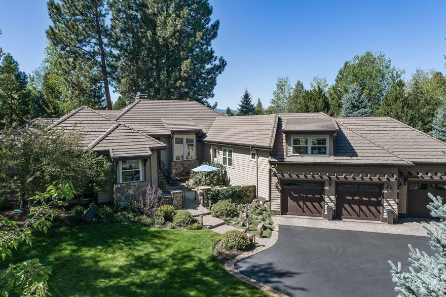 Backing to protected greenspace, this mostly single-level home is designed for both indoor and outdoor functionality, featuring front and back enclosed paver patios, ample storage, a workshop, and an oversized garage. With 12' ceilings and abundant windows, the home is filled with light, privacy, and natural beauty.
The great room balances an open feel with defined spaces for relaxing, reading, or connecting. The kitchen is ideal for preparing or entertaining, offering a large island, wine bar, walk-in pantry, and high-end appliances. The main level includes 4 bedrooms, an office, and a versatile flex room just steps up, providing space for living, working, or hosting.
Located behind the gates of one of Bend's finest neighborhoods, this home offers the tranquility and privacy you desire, with easy access to trails, town, and all the amenities that make Bend's westside so desirable.