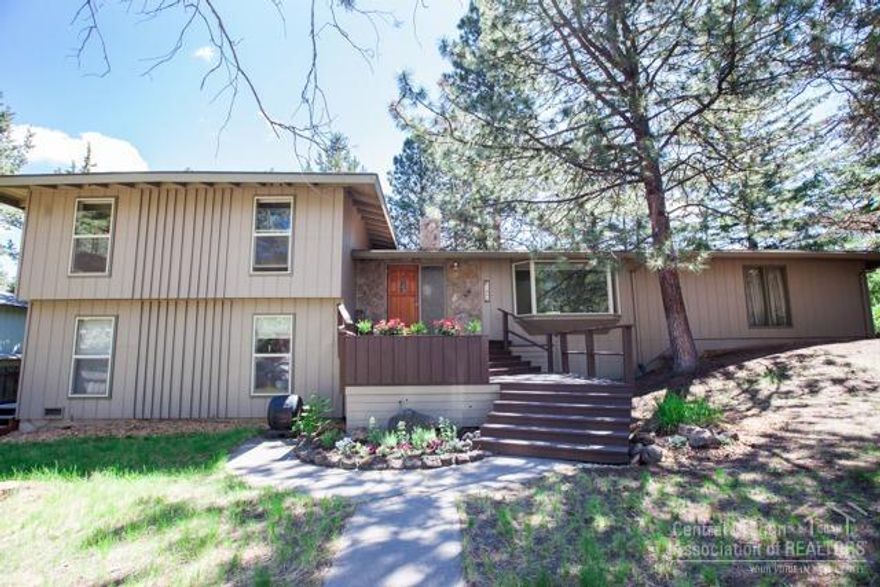 This midcentury home is one of a kind, nestled into a cozy and mature pocket of mid town. Providing plenty of space and privacy on a quarter acre, surrounded by large ponderosas and only a block stroll to Hollinshead Park. Separate downstairs living quarters with private side yard entry include laminate hardwood, radiant floor heating, kitchen, living room, bedroom and bathroom. Large rock outcroppings, multiple level decking and a hot tub await. This is a true gem.