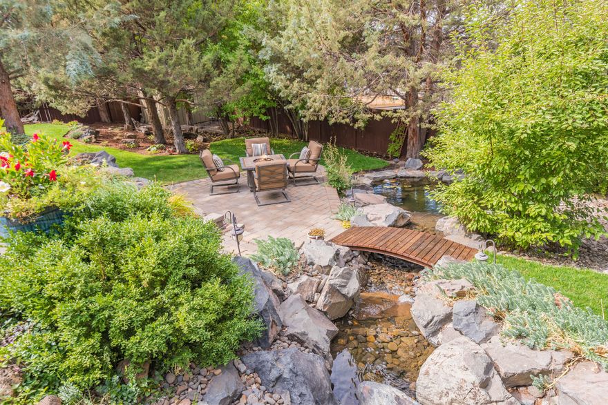 Come take a look at this gorgeous home tucked away in a private neighborhood with a large lot. Enjoy the mature grounds from one of the many private patios in the backyard as you listen to the cascading water feature while grilling on your plumbed gas BBQ. The property boasts RV parking with full hook-ups and sewer dump as well as raised vegetable beds, and a separate fenced area for pets or play. Park in your spacious 3+ car garage and then head into the shop/storage space that's just as roomy. Inside the home, you are welcomed with vaulted ceilings, wood-burning fireplace and an open living plan. If that doesn't work for you, there's a separate office/bedroom and separate family room for everyone to find their place. Head upstairs where you'll find a spacious primary suite that has its own deck with peek-a-boo mountain views. There are an additional 3 bedrooms as well as a nook that's perfect to read, work or play in. Welcome home!