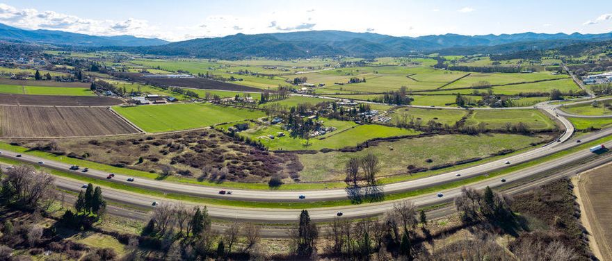 Great location along Hwy 99 & I-5.  2 Tax lots with a total of approx.. 31.95 Acres zoned EFU (Exclusive Farm Use)  Fully irrigated from Rogue River Valley Irrigation District. No home-site, septic or well.