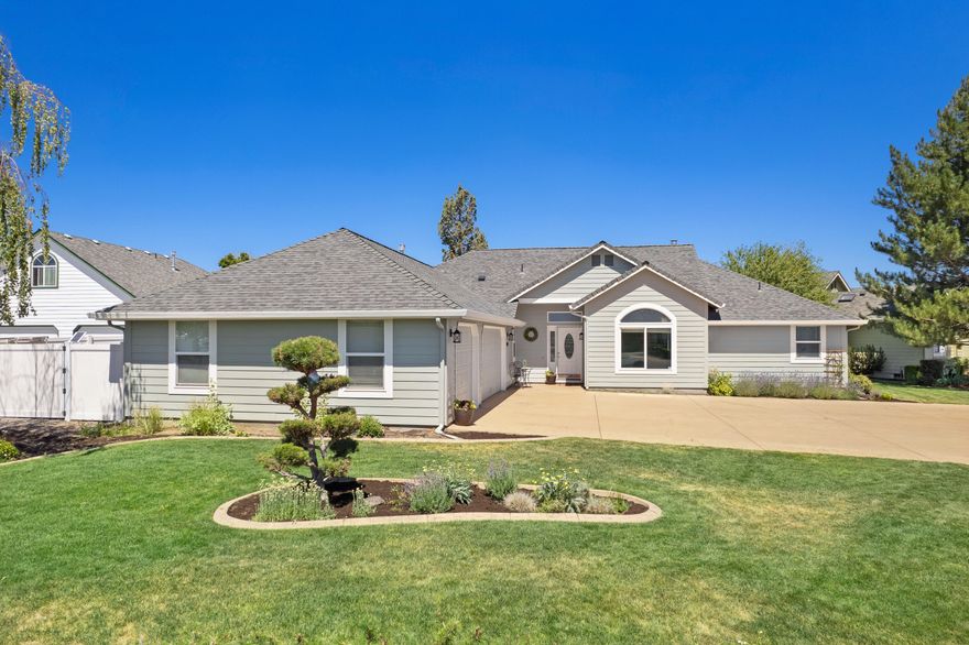 Lovely, single-level living in The Greens in Redmond! Come enjoy life in this updated & spacious home featuring vaulted ceilings & an expansive great room. The oversized windows let in natural light & boast views of the gorgeous, peaceful, backyard, with view of canal from the deck. The layout also includes a versatile bonus room, perfect for a home office or an additional living space. The updated kitchen includes stainless steel appliances with granite countertops, pantry & eating bar. Large primary suite has sliding doors to deck with hot tub & the bathroom with dual vanity & walk-in closet. This home includes the convenience of central air conditioning, central vacuum system, & ample storage space in the garage. Situated on a desirable corner lot, the property boasts dedicated RV parking with an electronic gate, making it easy to accommodate all your outdoor toys. Plus trail entrance nearby. Don't miss the chance to call it yours!