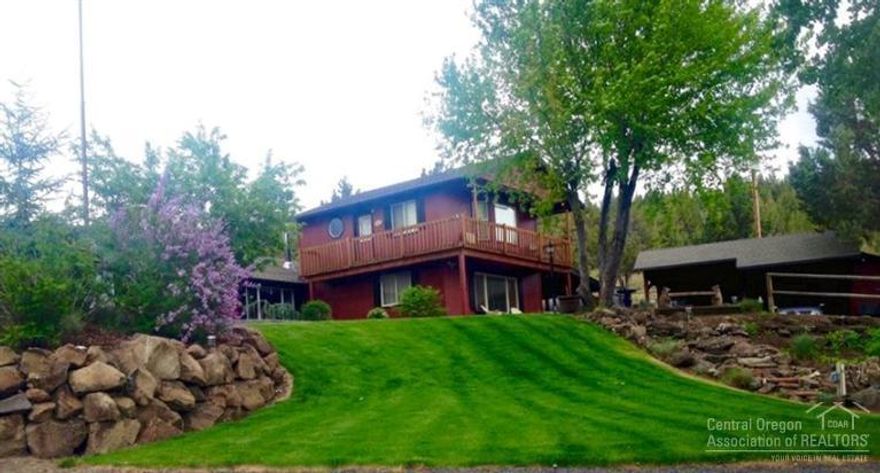 Are you looking for that perfect slice of Heaven? Nicely updated 2750 SF home with new shop, barn and multiple outbuildings on 5 acres. 4 bedrooms (one used as an office, 2 masters), 3.5 baths, workout room w/sauna. Sunroom/Sewing/family room. Gorgeous yard, new underground sprinklers, warm water well @ 35 GPM. Beautiful water feature. Too much to list! Private setting just 4 miles to town, close to Bend, airport and hospital. 4 +/- IRRIGATED ACRES!