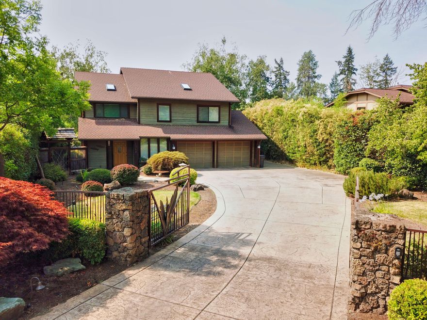 Rogue River waterfront living at its finest. This is what you will find upon entering this lovely home. It doesn't get much sweeter! Enjoy your wall of windows which face your beautiful rolling lawn to the waters edge. This home features creamy Corian counter tops in the kitchen which perfectly compliment the richness of the gorgeous cherry wood floors that flow through out the home. High end window coverings, including custom Shoji screens, provide privacy. The large primary bedroom features an en-suite bathroom with its own gas fireplace and soaking tub over looking the river. On the ground level you will find a 1500 sq ft stamped concrete patio, red cedar ceilings, complete with an in ground fire pit connected to natural gas. Sit in your like new hot tub and bask at the stunning beauty of your river front back yard oasis. Bonus! The custom wine cellar is located close by. The best Grants Pass has to offer on the famous Rogue River is just a phone call away.
