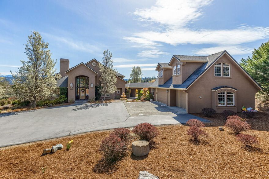 This is the reason why people want to live in Southern Oregon; this Pagnini-built country estate is located at the end of a private drive minutes from historic Jacksonville on 2 acres, providing a comfortable quiet country feel w/ the conveniences of town. Lots of room for hobbies w/ a semi-detached finished 3+ car garage, RV parking, & 770 sf guest quarters w/ a full bath & kitchenette. The Tuscan style home features an open floor plan w/ soaring ceilings & lots of natural light, w/ amazing mtn & valley views. Downstairs has chef's dream kitchen w/ sub zero fridge, double ovens plus convection oven & Wolf gas range & warming drawer, a huge island, & a butler pantry w/ a wine fridge & walk in panty. The downstairs also features both informal & formal dining areas, & the LR has a gas f/p w/ built-ins. The primary bedrm is on main floor & features a gorgeous ensuite bath & an office w/ built-ins. Two additional primary bedrms are located upstairs. Well produced 11.9 GPM when last tested.