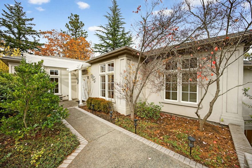 Just four blocks from Downtown Ashland, this freshly updated 1996-built home sits above the library with fantastic mountain views. A brand-new roof, refinished hardwood floors and carpeting create an inviting and refined ambiance. Ten-foot ceilings on both levels enhance the bright and open feel. The main level features two spacious primary suites, a well-appointed living and dining area, a kitchen, a great room with an office nook, and a spacious veranda perfect for enjoying morning coffee or relaxing evenings. The lower level adds great flexibility with a private 3rd bedroom and full bath, its own entrance, dedicated storage, a 3-car garage with a deep RV bay, and an oversized bonus room perfect for media, art, or fitness. The low-maintenance yard features mature landscaping and sprinklers. A charming detached 900 sf 2BD/1BA ADU cottage with its own entry is included in AS-IS condition. The total finished living space of the house and ADU is 4,120 sf, comprising 5 bed and 4 baths.