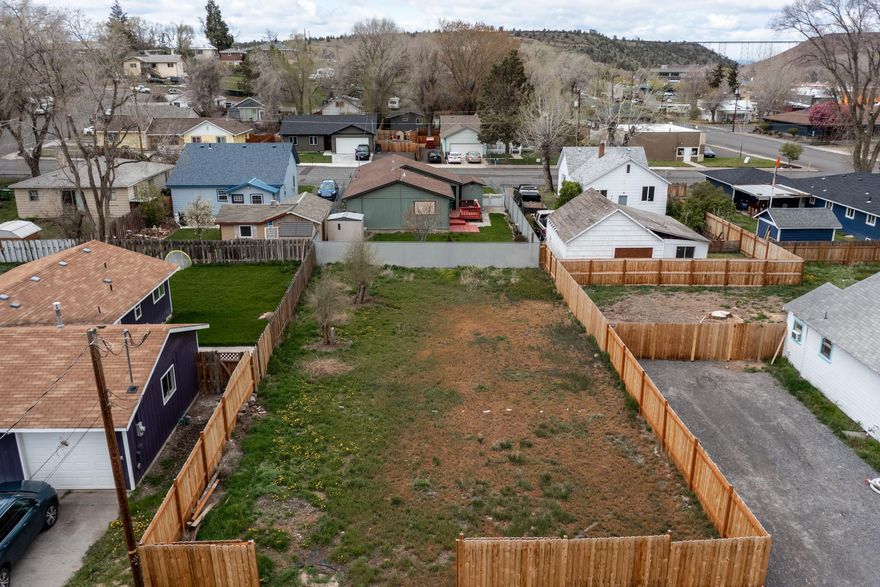 Flat buildable lot centrally located with utilities located to the street and freshly fenced this year. .11 acres - close proximity to parks, schools and the downtown corridor. Surrounded by mature trees in an established neighborhood.