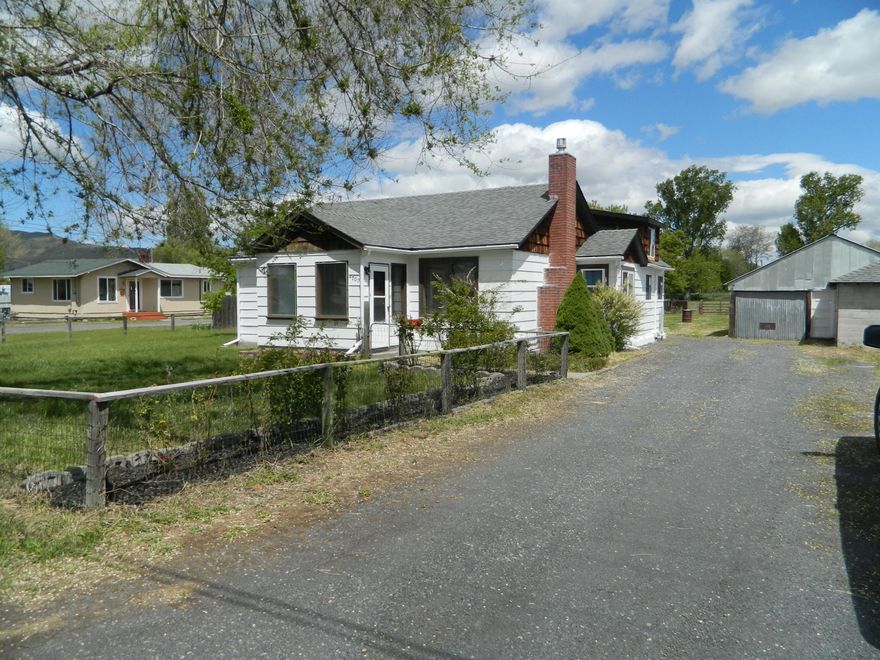 Hard to find property with acreage in town. This 2 bedroom 1 bath home sits on 1.5 acres with irrigation.Great property for horses or other 4-H animals. The house has a 1 car detached garage with a separate workshop area along with a covered RV area and covered dog kennel. Plenty of room to build a large shop and still have room for everything else