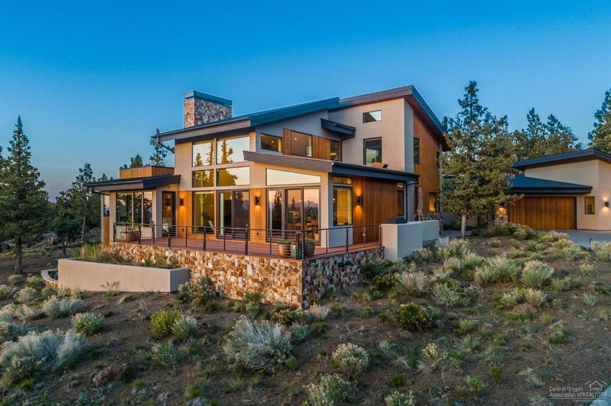 Spectacular Cascade Mountain views fill nearly every room of this stunning modern masterpiece. Serene and architecturally balanced with clean lines and a flowing open floor plan, the custom home features a stunning great room with expansive windows & clear white oak floors, gourmet kitchen with Sapele horizontal grain-matched cabinets, high-end stainless appliances, solid quartz & granite surfaces. Four en suite bedrooms, including a gorgeous main level master, office, 4.5 baths, loft + separate rec room provide ample space for family and guests. Outside, enjoy 3 outdoor living areas: main level & roof top decks with panoramic Cascade vistas + a spacious courtyard patio with spa, water feature and glass fire pit. Built to Earth Advantage Platinum standards & with exceptional quality, this high-performance home is insulated for tranquility & energy retention. Includes solar, radiant floor heat + natural gas HVAC for year 'round comfort.