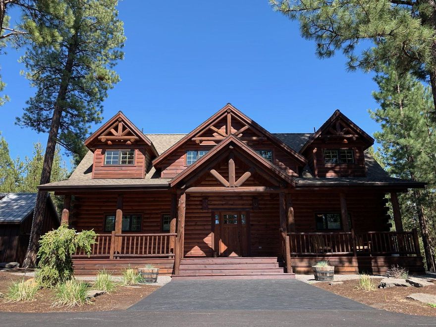 Custom Log Home that includes additional 1 acre lot (15164 Yellow Pine Loop) backs to Deschutes National Forest.  River rock fireplace in great room with 28'  ceilings.  Newer kitchen with hickory cabs & slab granite.  Island with eating bar.  SS appliances including double oven gas range.  Pantry in kitchen.  Hammered, copper farm-style sink. Main floor master with double sinks, tiled shower, jetted tub and water closet.  2nd and 3rd bedrooms are full JR suites with tiled showers, single sinks and jetted tubs. Log staircase leads to the JR suites separated by vaulted loft with pool table, sitting area and pub table (all included with sale). 10'' wide plank flooring and pine tongue and groove walls and ceilings. 28 x 36 three car garage with over sized doors and large attic trusses (1,400 sqft total) offering huge storage area.  16 x 22 shop with loft. Covered front porch.  Large deck.  Paved circle drive. Fall River approximately 630' behind the home.  Minutes from Sunriver Village.