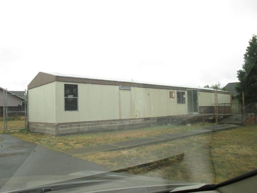 Great lot that could support either a nice home or several multifamily units. The home that is there is a 1980 Manufactured home that is in need of repair. Buy this property and repair the home and live affordably or remove and build duplexes or apartments or ? This is a great property for the price.