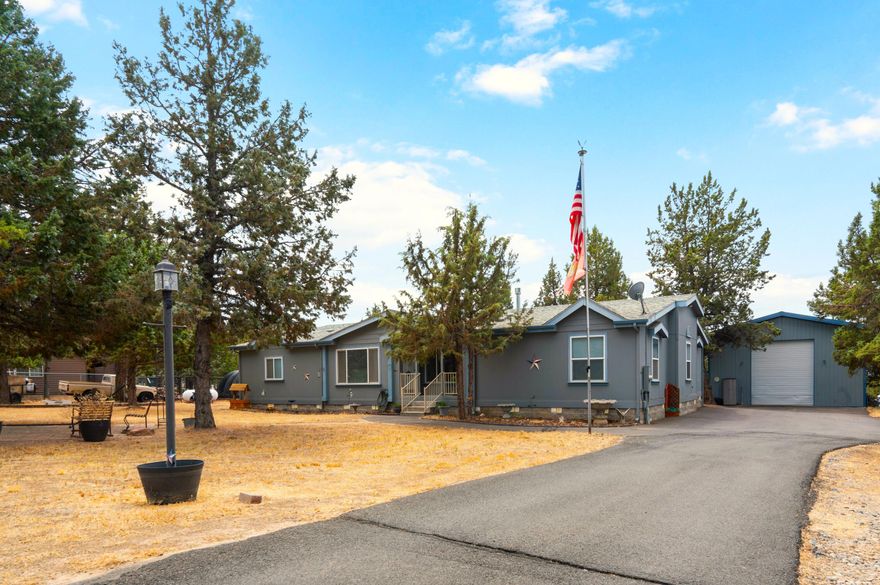 Expansive 2,668 sqft home offering mountain views & spacious living inside & out. An open interior layout welcomes you into a front living room w/double-sided wood-burning fireplace, formal dining area, & large family room warmed by a freestanding propane stove. Bright & open kitchen ftrs stainless steel appliances, skylight, central island w/storage, & large corner panty. Primary suite boasts a sitting area, bath w/soaking tub, walk-in shower & dual vanities. 3 addtnl bedrooms share a full bath as well. New heat pump w/air (2022), all new ductwork, & new smart thermostat. 1,800sf shop w/15' roll-up door, 110/220 power, storage room, space for entertaining & 4 full-sized vehicles. Cyclone fencing surrounds the property, which includes a gorgeous fire pit area, low maintenance landscaping, animal shelter w/fenced pen, covered gazebo, shed, & paved RV/toy parking. Located in the desirable Crooked River Ranch w/golf, tennis, pool, club house, restaurants, park & much more!