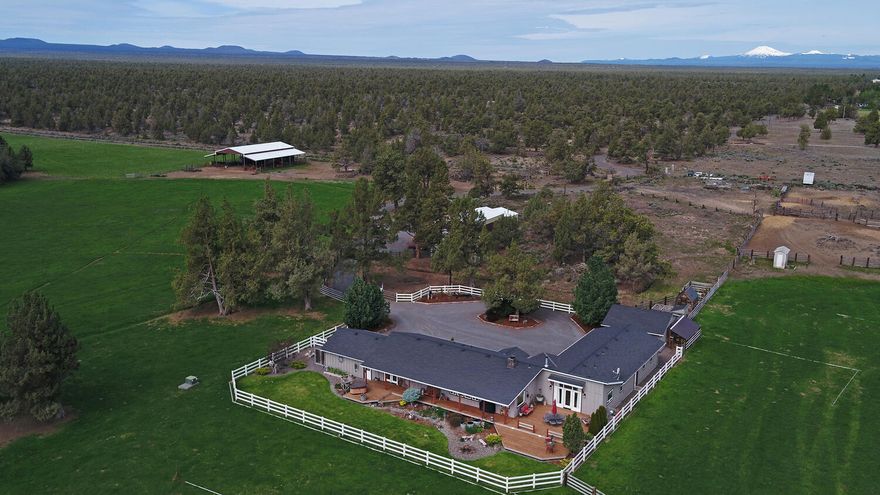 This private ranch property blends natural beauty with practical amenities across 84.93 acres, with 48 acres of COID irrigation. With direct access to public lands, outdoor adventure is right at your doorstep. The home welcomes you with a spacious great room, a floor to ceiling stone fireplace, a sunlit dining area, and sweeping views of the surrounding landscape. The updated kitchen includes an island cooktop and pantry, perfect for culinary enthusiasts. Equestrian lovers will appreciate the 5,040 sq. ft. hay barn, easily adaptable to horse stalls or an indoor arena. Additional structures include a dedicated water storage building and a finished 575 sq. ft. space with a bath—ideal for ranch help, creative projects, or a private studio. Efficient irrigation is ensured with two pivots, making land management a breeze. Whether you are seeking a working ranch, a hobby farm, or a peaceful rural lifestyle, this Central Oregon gem offers space, versatility, and endless possibilities.