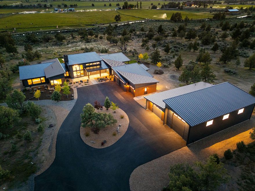 Stunning Grandview Estate in Powell Butte, Nestled on 9.67 Acres with Breathtaking Mountain Views. Meander through the Custom Gated Driveway to the Sprawling Single Level Mountain Modern with Contemporary Style and Picturesque Windows. Spacious Great Room with 16ft ceilings, Custom Iron Wood Burning Fireplace, Amazing Slider to the Covered Back Patio with Custom Fire Pit and the Sparkling Water Feature, Privacy and Views. Kitchen boasts large Quartz/Stone Island with Underlighting, Jen Air Appliances, Butler Pantry with Floating Shelves. Luxury Primary Suite features Stone Wall with lighting, Private Covered Patio with Hot tub, Elegant Primary Bath with Porcelain Heated Floors and Shower, Custom Walk-In Closet.  Bonus Room with Wet Bar, along with Two Guest Suites. Attached Three Car garage with Safe Room, Detached RV Garage with potential for an ADU - 732 SF Flex space with bathroom and laundry. Come Tour this Home Today!