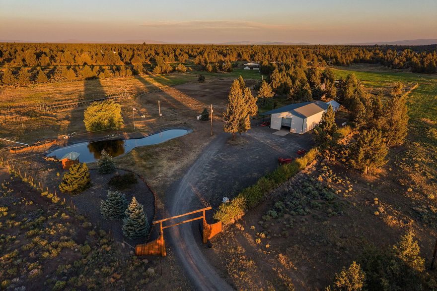 Your Central Oregon rural property DREAM come true! Perfectly located between Bend and Redmond, and minutes from all local amenities. You'll first be met with a grand entry gate to the 10 acre estate. The move-in ready home is complete with tile and laminate floors, vaulted ceilings, vintage sunk-in living room with a cozy gas fireplace, large picture windows, skylights, outdoor balcony, all appliances, and plenty of space for living, a remote workspace area, and your guests! There is an ''optional'' ADU suite attached with a separate entry too. Outside, you'll find a sizeable greenhouse, pumphouses, and an impressive 4000sf heated & insulated shop, 9 irrigated acres with Swalley Irrigation, breathtaking views of the Cascade Mountains, and a sparkling pond complete with a playhouse. Fully owned solar panels source the hot water system. You've been waiting for your perfect rural adventure property - don't miss this one!