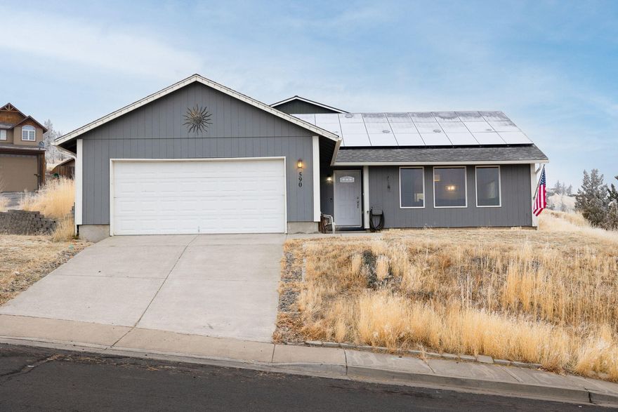 Beautiful south-facing 3 bedroom 2 bathroom home located in Park Place neighborhood near downtown Madras. This light and bright 1704 sqft home has an open floorplan with vaulted ceilings in the living area and ample cabinet space in the kitchen. Primary bedroom has walk-in closet. Home is equipped with solar panels, and upgraded heating/ cooling units. Has a double car garage and is situated on a corner lot with ample room for parking and taking in the views.