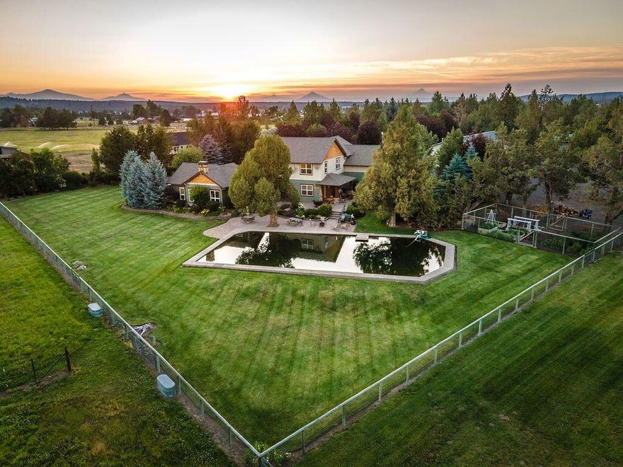 This gorgeous equestrian estate exemplifies country living at its finest! Located in Tumalo, a highly sought-after area of Bend with mountain views, this estate features a beautiful 4bd, 3.5 bath, 3755 sq. ft home situated on 9.49 acres. Extensive horse facilities and nearby trails make this everything the horse enthusiast would want. Impressive barn, paddocks, and Day Money arena. Room to garden, entertain, and live a quiet, fulfilling life. New England/Traditional style home with 2 master suites. Main master on ground level with secluded courtyard & hot tub. Luxurious master bath with walk-in closet, clawfoot tub, and private washer and dryer. Quality propane fireplaces. Wired surround sound system inside & out. Bonus room upstairs with vaulted ceiling and office. 3.6 acres of underground, automated irrigation. Three-car garage, shop, tack room, outdoor & indoor RV space, and kennel with a heated dog house. This estate can facilitate so much. It is truly a must-see!
