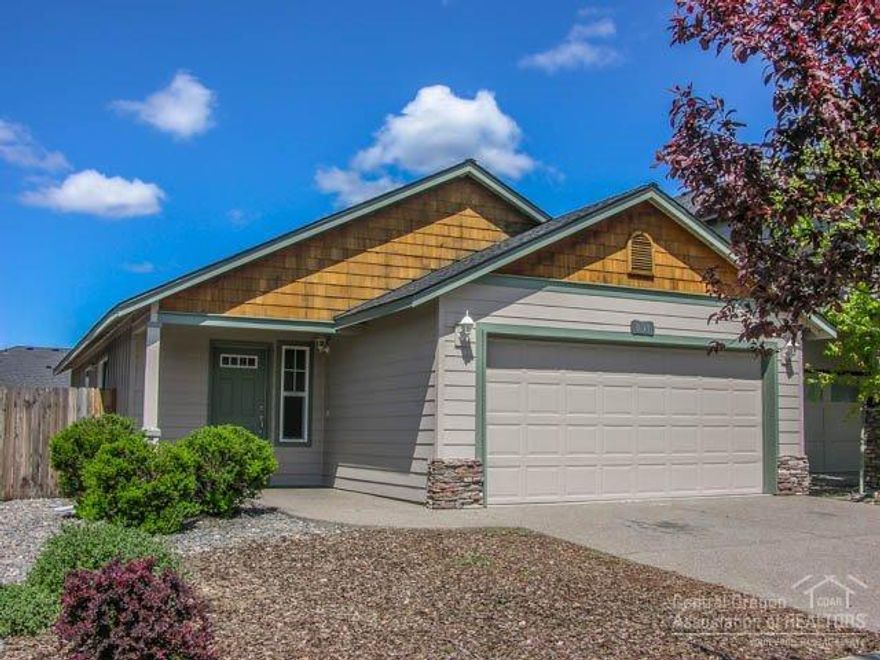 Super Cute Single Level Bend Home in Like-New Condition! This wonderful 3Bd/2Ba ranch style home is move-in ready'' featuring: exposed aggregate driveway, stone & shake fascia, tiled entry & vaulted great room w/new hardwood flooring, open kitchen with tiled counters, B-Bar center island, custom archways, vaulted master w/walk-in & private bath w/tiled vanity, Gas FA heating & HW heat, attached insulated 2-car garage w/work bench, fully fenced yard w/paver patio & patio set, and 1yr new paint too!