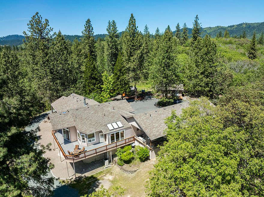 10 private forested acres of peace, quiet & amazing views. This estate is perfect for entertaining guests w/ space to enjoy all your hobbies & critters. Pretty curb appeal, landscaped w/paved circular drive. 3800 s/f custom home; a furnished 600 s/f guest house, a finished & insulated 4-car garage/shop, plus a (wood-working) shop plus a 4-stall barn; all this set in the gated neighborhood of Sexton Heights just 20 minutes from Grants Pass. Cook's kitchen w/ slab granite island, salad sink, insta-hot water, sub-zero fridge, 6 burner Jenn-Air cook-top. Central vacuum. 10ft - 14ft ceilings, 8 ft sliders, wrap around Trex deck. Wood burning fireplace. Heat pump. Portico w/ hot tub, built-in gas BBQ. Built w/16-inch joists, 25R ins, 3 inches anti-fire/sound absorber between floors. 20 x15 shop. Steel frame barn & 2(25x80) pens, all w/ water & power. Woodshed. Block bldg w/ generator. RV parking & hookups. 2000-gallon pond & waterfall. Turnkey w/ Inspections & Home Warranty. By Appt Only.