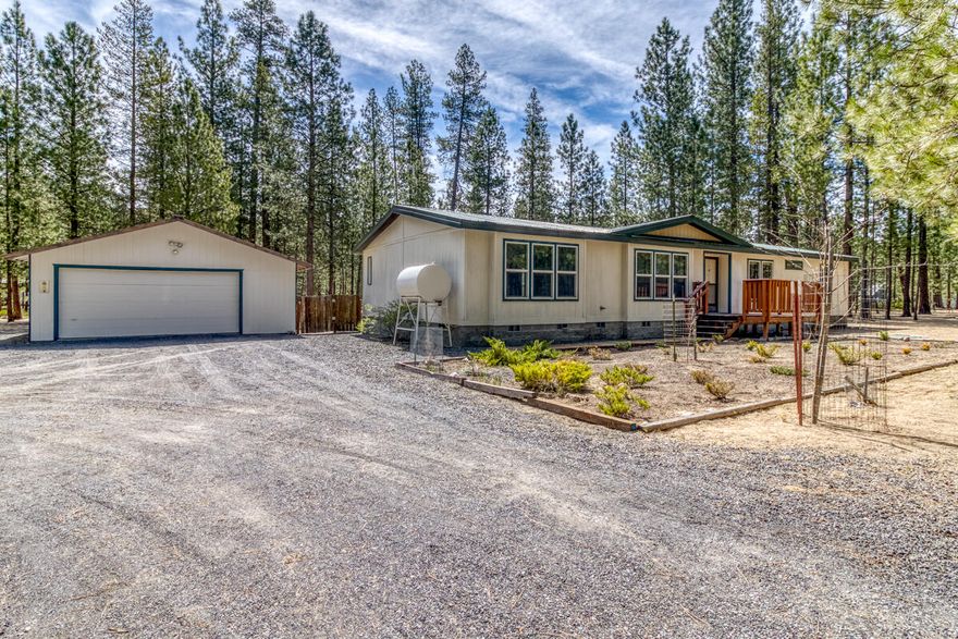 This diamond in the rough is tucked into tall pines in desirable Ponderosa Pines community. A well cared for home is awaiting your personal touch. Split bedroom floor plan w/primary en suite at one end and 2 additional bdrms, bathrooms &laundry/mud room w/ jack and jill bath access at the opposite end. Great Rm style living area & well appointed kitchen and separate dining room. Features high ceiling, both Monitor oil stove & forced air electric heat. Fenced in back yard w/deck, large detached garage & storage sheds on 1.55 ac lot. House has metal roof, front porch and circular drive. Property is neatly maintained and main roads are cared for, including snow removal, by the HOA. Community water .Go to PPPOA website for all information about HOA and Water Co, including water purity reports. Good price, great neighborhood...what are you waiting for? Call for your personal showing TODAY!!!
