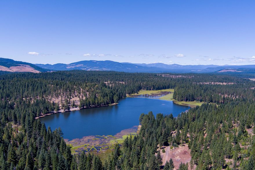 Rare opportunity to own 160 acres at Medco Pond with homesite approval. With some tree clearing, enjoy stunning views of the 64-acre pond, stocked four times a year with rainbow trout and home to bass, crappie, and more. Crane Creek runs through the property, attracting elk, deer, turkey, and other wildlife. Includes 2 LOP tags. Just 30 minutes to Crater Lake National Park and close to Sky Lakes Wilderness, Rogue River, and Lost Creek Lake for year-round outdoor recreation. Nearby BLM and Forest Service land offers additional space for hunting, fishing, and exploring. Rogue Valley International Airport is less than an hour away, making access convenient for out-of-town guests or a future retreat. Originally developed in 1945 as a log-holding pond, Medco Pond is now a serene and historic setting. This unique property blends natural beauty, recreation, and development potential—an ideal setting for your future home, cabin, or private retreat.