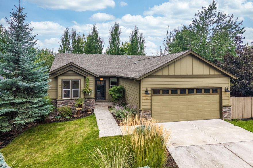 Adorable single-level home showcasing upgraded engineered wood flooring and an inviting layout with great natural light. The kitchen features sleek stainless steel appliances, blending modern style with everyday function. A shiplap design above the fireplace adds charm and character, while surround sound capability enhances entertainment options. You will appreciate the separation of the primary bedroom from the rest of the home. The fully fenced yard creates a private outdoor retreat ideal for pets, gardening, or relaxing evenings. Designed with comfort and convenience in mind, this home pairs style with low maintenance living. Located in a peaceful neighborhood, residents enjoy close access to parks, nature trails, and the scenic Deschutes River Trail, as well as shopping, dining, and everyday amenities. A nearby nature park offers even more opportunities to enjoy the outdoors.