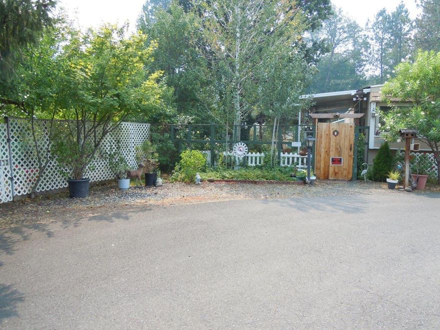 Great park location with nicely landscaped yard in a 55 and older park. Outbuildings consist of 10x24-carport, 6x8-greenhouse, 2-storage buildings 6x8 & 8x10, you have an 8x14-covered deck with ramp access. Space rent is $315/month, sewer $47.00 and water up to 3,000-gallons $25/month. What a nice quiet place to be.