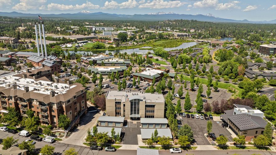 Welcome to The Atrium-where luxury meets lifestyle in one of Bend's most coveted locations. Nestled in the vibrant Old Mill District, this stunning condominium offers front-row access to shopping, dining, concerts, and riverfront trails - all just steps from your door. Soak in breathtaking views of the Cascade Mountains and the iconic Old Mill smokestacks from your private, oversized deck, complete with a gas hookup for effortless outdoor entertaining. Inside, the light-filled open floor plan boasts high-end finishes at every turn: white oak hardwood floors, sleek European cabinetry, Silestone countertops, radiant heated bathroom floors, & custom-finished closet systems throughout. This serene and private unit offers secure, elevated living w/a private two-car garage, heated driveway, secure keypad entry lobby, elevator access, and two generous interior storage closets. As a rare bonus-short-term rentals allowed. Co-listing Agent related to seller.