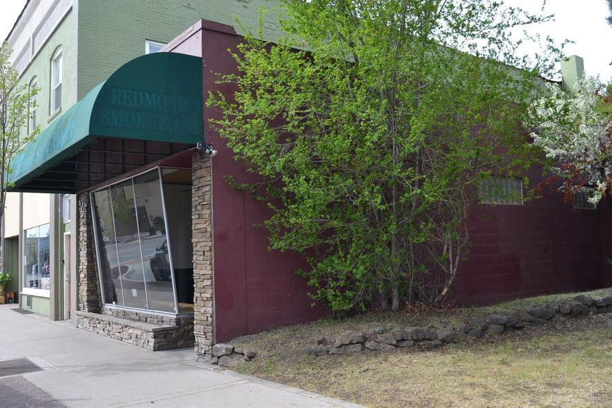 Commercial building is located in the Central Business Core of Redmond. Glass storefront entry, open showroom, one bathroom, some wall racking in place.Building has a nostalgic feel and charm, with old vault and shelves. Attractive exterior with stone accents, rounded awning for signage, extra parking in rear, N. side is landscaped. Zoning allows for most retail or office uses. Side yard, excess land area that could be used for outdoor seating etc. Prime location, perfect owner/user or investment property