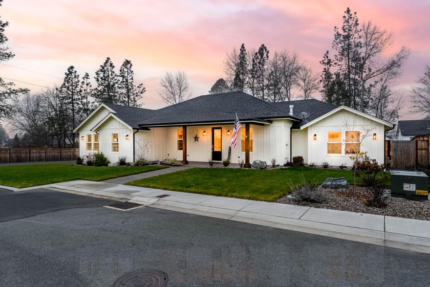Rare single-level living on nearly an acre inside the city limits of Grants Pass. Built in 2023, this custom home offers 2,571 square feet of thoughtfully designed space in the desirable Twisted Pine community, combining modern construction with room to breathe while remaining minutes from downtown, medical services, shopping, and dining. The interior is bright and open with vaulted ceilings, hardwood floors, chiseled granite counters, and abundant natural light. The kitchen is designed for everyday living and entertaining, featuring a large island, breakfast nook, and oversized pantry. The primary suite provides a private retreat with a spacious walk-in closet and tiled shower, while a dedicated office adds flexibility. Outside, the .82-acre lot offers privacy and usability, complemented by a covered patio and a newly built 24x28 detached shop or garage ideal for vehicles, storage, or hobbies. A seasonal creek creates a natural buffer without limiting usability.