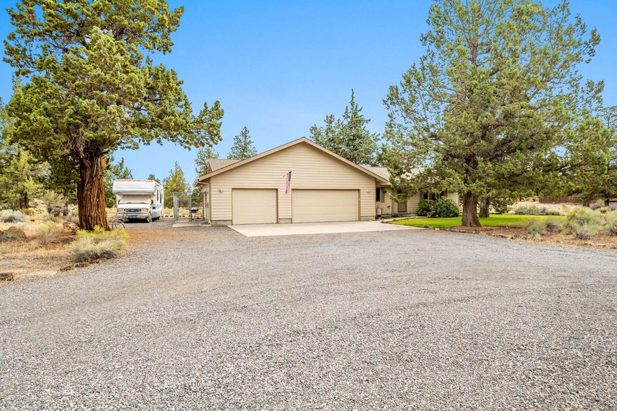 Set back from the road on 2.64 private acres amid old-growth junipers, this single-level home has been recently renovated with high-quality features and finishes. In addition to vinyl waterproof flooring, new interior paint, and new indoor and outdoor lighting throughout, the kitchen has been upgraded with quartz countertops and a subway tile backsplash, a French door refrigerator, a cast iron farmhouse sink, bronze fixtures, and custom hand-troweled ceilings. The bathrooms mirror the kitchen finishes with high-quality bronze fixtures, cast iron vanity sinks, quartz countertops, and custom tile backsplashes, as well as a cast iron bathtub in the primary ensuite. The home is bright and airy with abundant natural light and a vaulted great room. Additional features include spacious decks, a fenced dog run, RV parking with full hookups, a 3-car oversized attached garage with plenty of storage, and a mud room.