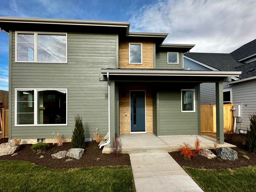 Welcome to this stunning 2,302 sq ft new home by Stone bridge Homes NW, blending modern design with thoughtful details. A charming covered front porch invites you inside to open-concept living with a spacious great room, dining area, and chef's kitchen featuring a large central island, quartz countertops, and a generous corner pantry. Enjoy seamless indoor-outdoor living with a covered patio opening to the fenced backyard. Upstairs, find four bedrooms including a luxurious primary suite with dual vanities, a tile shower and a walk-in closet. A versatile loft, full bath and convenient laundry complete the upper level. Alley-loaded two-car garage adds curb appeal and functionality. Perfectly designed for comfort, style, and everyday living!