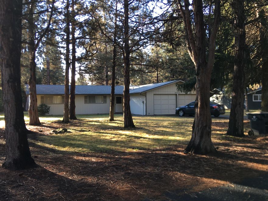 Nestled in Tillicum Village, this one level home on .30 acres is ready for your new adventure!

The 3 Bedroom, 2 Bath Home has been lovingly maintained by the original owner/family, and has provided years of gatherings and memories.  Mostly original, you will find the home to be move in ready, yet also the perfect home to invest your remodeling and decorating skills!

The large level lot has room for outdoor activities, RV parking, and space for you to relax and enjoy the deer and wildlife that pass through daily.

Tucked away off the beaten path, but close to shopping, the Old Mill District, walking paths, and all that Central Oregon has to offer, your adventure is right outside your front door.

On those cold and chilly nights, you will be greeted by the retro round fireplace that the family enjoyed for many years, and a slider off the back leads to a patio for outdoor living and BBQs in the summer!