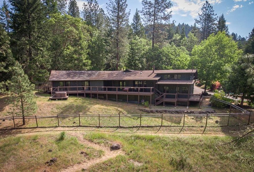 There's a reason guests of this property's Airbnb cottage call it a Hidden Haven; beautiful, private, quiet, & peaceful w/ all the amenities. Its secluded, yet conveniently close to the highway & a short drive into Grants Pass. The 3044 sq ft, 3-bed, 2.5 ba main house is spacious w/ beautiful views, a large custom gourmet kitchen w/ granite countertops & walk-in pantry, a jacuzzi tub & walk-in closet in the master bath, office w/ a built-in desk and cabinets, custom cabinetry, wood stove, & lots of storage. This home also offers a unique floor plan w/ all three large bedrooms separate & far apart for privacy. The 2-bedroom, 1-bath cozy cottage is perfectly suited for guests or as an Airbnb w/ a mini-kitchen & living room/dining room. The barn has been tastefully remodeled into an open workshop/studio. Its a place where you can relax, entertain by the pool, tend your garden, walk along the trail to the creek, play at the shooting range, or enjoy the hot tub under the stars.