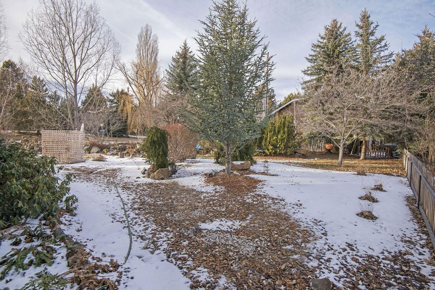 Welcome to Bend! Come build your dream home in the Boyd Acres View Estate, featuring a beautiful park like setting. This .18 acre lot has all utilities on or next to the property, is nearly level, offering mature fruit trees, yellow and red raspberry bushes, with a water feature and stone pathways. This lot provides you the perfect setting to call home.  Call your favorite agent and come build out your dream today.