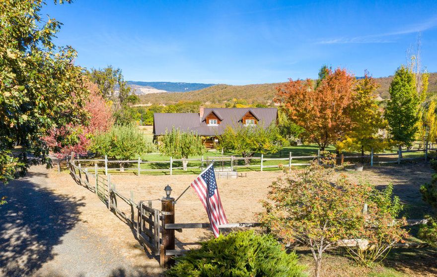 Welcome Home! This immaculate close-in rural property has so much to offer. There is a gorgeous home with quality throughout, including hardwood floors, open and inviting kitchen and incredible natural light. There is a main level master with an adjacent office space & additional half bath. Upstairs has two additional bedrooms – both oversized and one with a private balcony, adjacent sitting room and office nook. Extensively tiled full bathroom. Gorgeous irrigated pasture, fenced/cross fenced. There is a seasonal creek running through the property, a charming barn, detached oversize two car garage plus an attached two car garage. There is a wrap around front porch and expansive deck around back. Incredible views in nearly every direction. This home sits nicely off the main road so it's peaceful, serene and really quite private. The property is fully irrigated combination of Hill Creek and TID. Strong well per owner, holding tank & UV Filter.