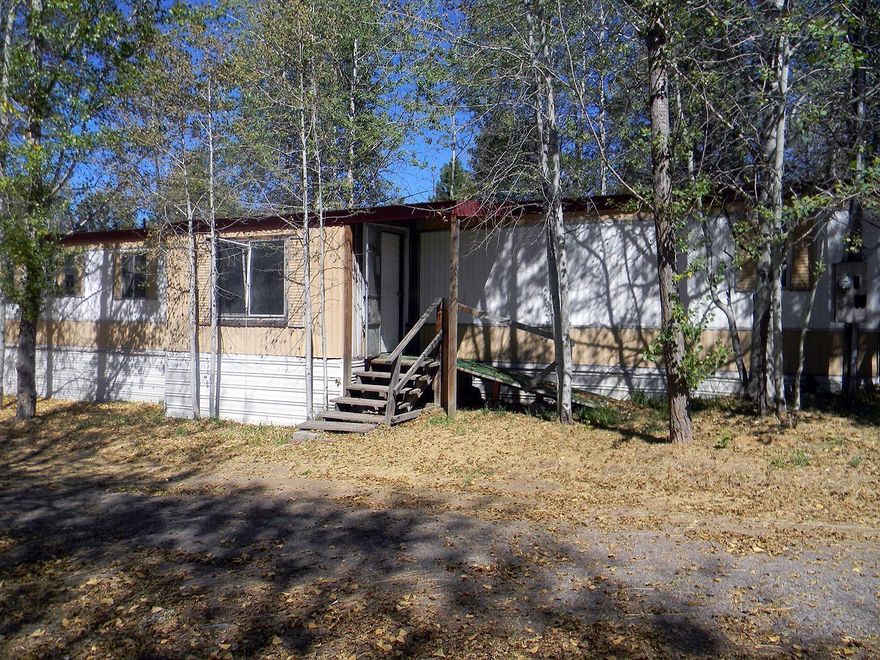 This Oregon Shores lot is a diamond in the rough! In a great location not far from Modoc Point Rd., the lake and the Williamson River. A nature lover has endless opportunities and this lot is very secluded and has mature Aspen trees creating a very quiet and seren feel. With nice mountain views, a community water system and maintained roads, this a great location for a dream home. Currently has an existing manufactured home on the lot that is not in great shape but has a new metal roof. The manufactured home could be removed and a new home built in its place. Manufactured home is 3 bedroom, 2 bath and 1008 square feet.