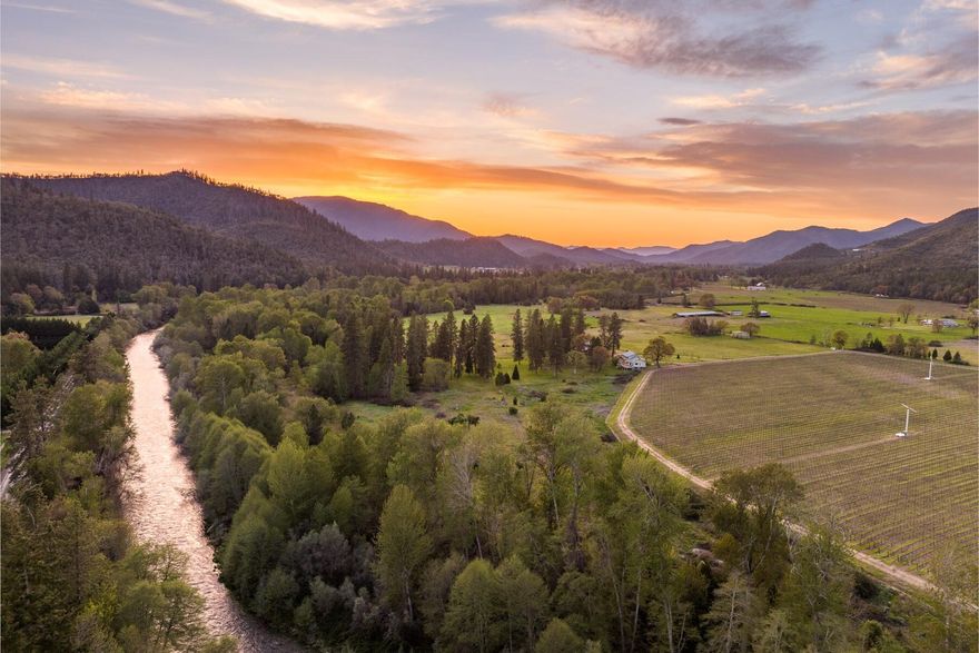 Welcome to the River Bend Ranch - A 52 acre, premier riverfront estate conveniently located in the middle of the Applegate wine trail. On the market for the first time in nearly 20 years this one-of-a-kind estate has over 3100 feet of private river frontage. Property provides an abundance of recreational opportunity, lending itself to fishing, waterfowl, upland bird, black bear and blacktail deer along this well-known steelhead fishery. Offering two homes, 38 irrigated acres, barn, and additional shop. 2nd homesite is held by older home with separate power, address, well, and septic.  Main home is 4,245 sq. ft. with primary bedroom on main level, remaining bedrooms upstairs on suite, plus additional living area and offices in the daylight basement. The park like setting has an abundance of flat area amongst mature oak and pine with tremendous views of Billy Mt and Wellington Butte. This unique property creates an unmatched escape only 20 minutes to town.