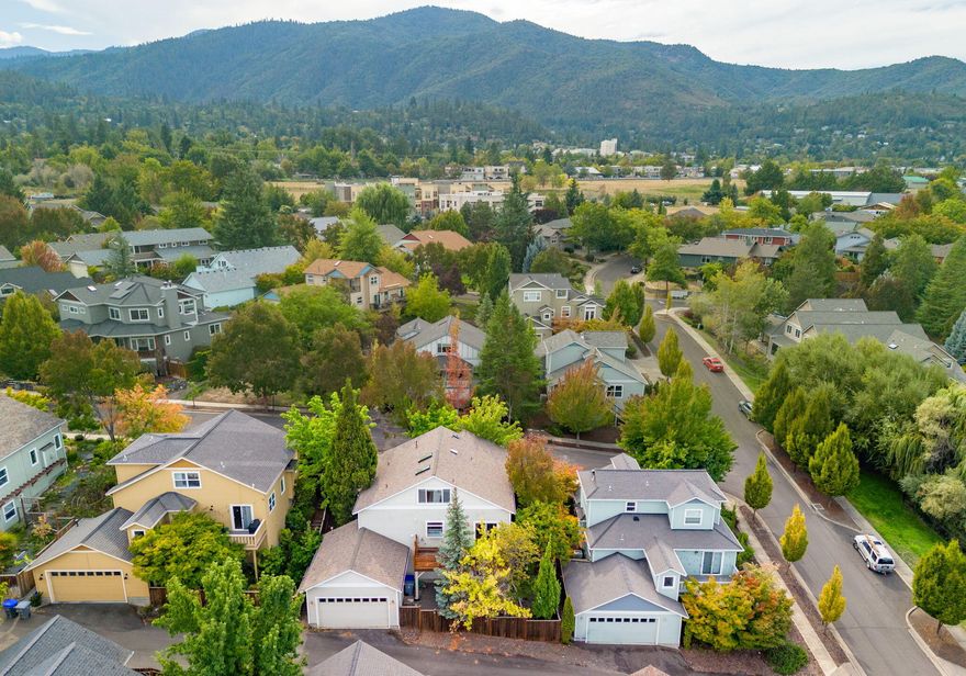 Nestled on a quiet, tree-lined street near North Mountain Park, this darling four-bedroom, two-bath single-family home offers the perfect blend of comfort, charm, and scenic beauty. Step inside to find hardwood floors throughout the main level, creating a warm and inviting atmosphere. The open dining area flows seamlessly onto a private deck, ideal for enjoying morning coffee or evening gatherings while soaking in the serene surroundings. The spacious primary suite is a true retreat, featuring an en suite bath and sweeping, unobstructed views of the mountains that will take your breath away. With three additional bedrooms, there's ample space for family, guests, or a home office. The property also
offers exciting potential for an ADU, giving you the flexibility to create a private guest suite, rental, or multigenerational living space. Just minutes from downtown Ashland, you'll enjoy easy access to shops, theaters, and dining, while savoring the peace of Southern Oregon living.