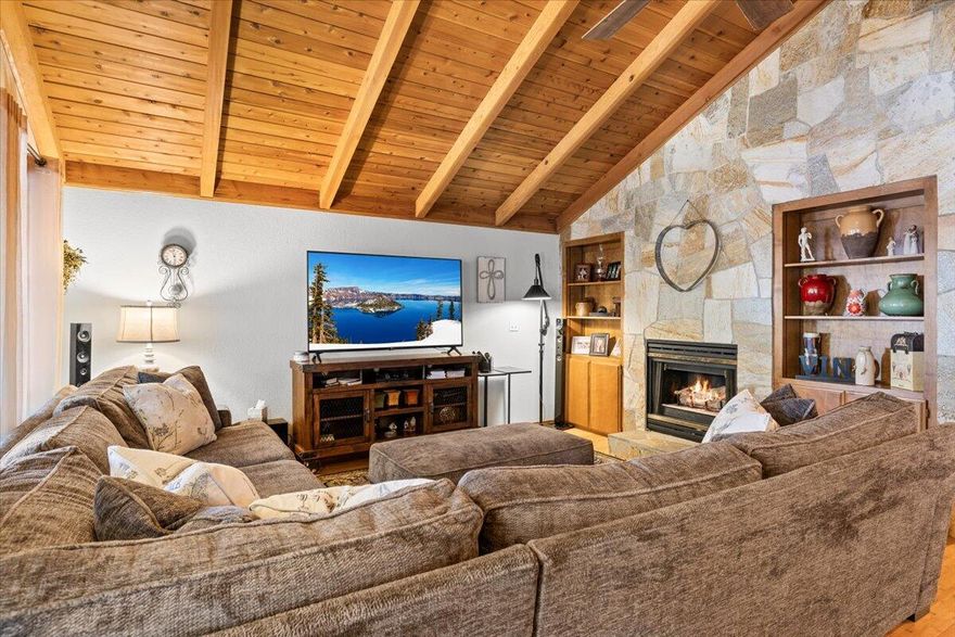 HOME WITH A 1000 SQ FT SHOP! Welcome to this spacious four-bedroom home features three full baths and a convenient half bath, boasting a generous 3,131 sq. ft. of living space. And a NEW ROOF! Step inside to discover a stunning master bedroom located upstairs, complete with an ensuite featuring a Jacuzzi tub. Downstairs is a  large secondary primary bedroom with its own bathroom with double vanity.  The living room showcases soaring vaulted ceilings adorned with beautiful tongue and groove (TNG) wood, creating a warm and inviting atmosphere. Need extra workspace? This property includes an impressive 1,000 sq. ft. insulated and heated shop, 220 V compressor, and 220 outlets throughout. Additionally, this home features an RV hookup on the side, complete with a septic dump, making it a perfect fit for adventure seekers. Don't miss the opportunity to make this exceptional property your own. ASK ABOUT THE 2.7% ASSUMABLE LOAN!