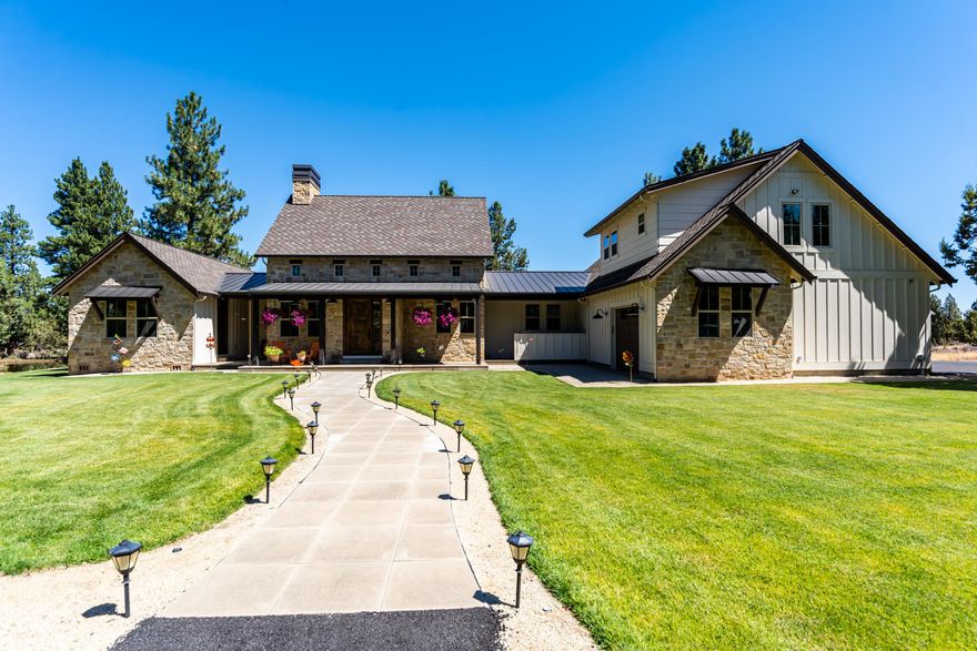 One-of-a-kind Texas style farmhouse resting on over 5 acres. Just minutes from Bend, you'll appreciate the convenience yet feel distanced enough to enjoy the serenity of private small acreage living. Down a long paved driveway, surrounded by mature pine trees and accented by the 2 acre irrigation pond. The exceptional great room offers large vaulted ceilings, exposed beams, floor-to-ceiling natural stone fireplace, 12' kitchen island and high-end stainless appliances. Main level master with vaulted ceilings features a walk-in tile steam shower, dual vanities, heated tile floors plus a walk-in closet with washer/dryer. Upstairs there are two bedrooms with full en suite baths, family room with wet bar and mini fridge. Plenty of room to work from home or home school with 2 separate office spaces; each with exterior entrances. This custom home is built with sustainable high-end finishes in every detail.