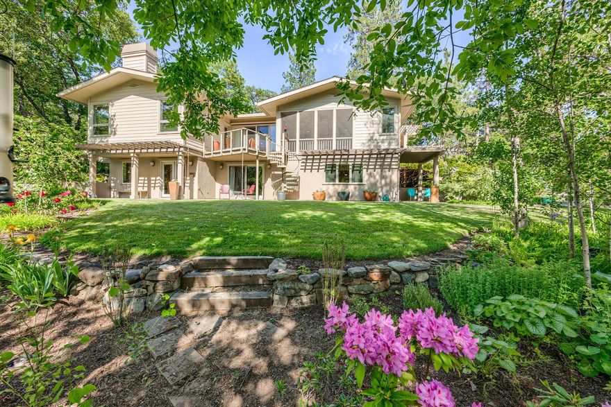 City elegance meets country living in this 4br/4.5 bath home on stunning 5ac estate in the heart of Southern Oregon's Applegate Valley. With 1000ft of Little Applegate River frontage you will enjoy the peaceful river sounds year round. Offering refined living, the elegantly appointed home features an open floor plan, chef's kitchen, vaulted ceilings,
hardwood floors, custom built-ins throughout including large library/crafts space. The primary suite has a luxurious ensuite bath and private deck access. Three more large bedrooms include an in-law suite with private entrance, perfect for guests or multigenerational living. Adjacent 1800sqft finished, insulated, temperature-controlled shop with 12ft clearance in work areas, office, and 1/2 bath. Enjoy outdoor living with mature landscaping, garden space, walking paths, direct river access, and 1865 water rights. Adjoining parcel also available MLS#220203058. 119 Acres EFU 1900ft of River Frontage.