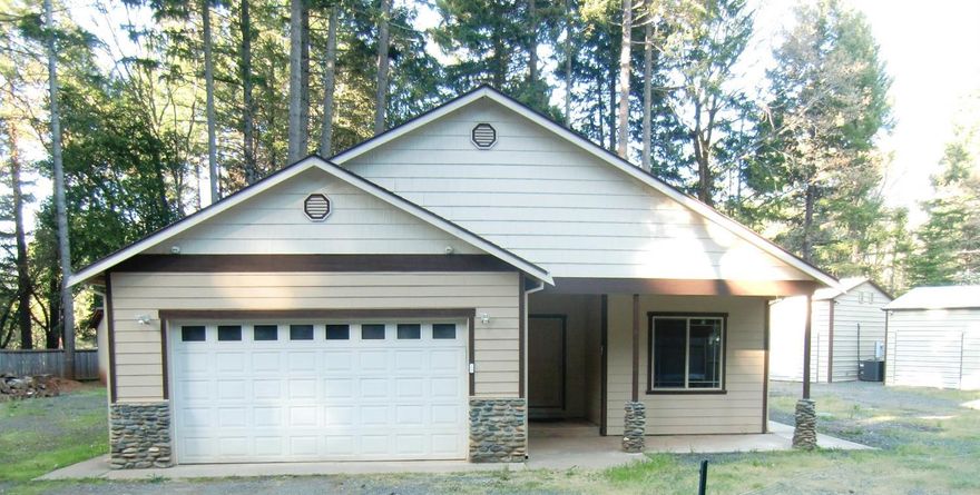 This 2006 built home is light and bright. There are 3 bedrooms and 2 full bathrooms, an attached 2 car garage and a good private well. The home is fully fenced on .54 acre featuring an open floor plan with a great master suite that opens onto the nice big patio. There are vaulted ceilings, a warm wood stove, and an office or den that could be used as a 4th bedroom. All household appliances are included in sale. The home was updated in 2016 and is in exceptional condition. There are two 20x30 shops with roll up doors. Both shops are fully insulated with a separate electric meter and heat pumps for climate control. There is a large fenced garden area, a rose garden, and four additional outbuildings that are fully insulated with electric power in. The setting is secure and park-like. Bring all offers.