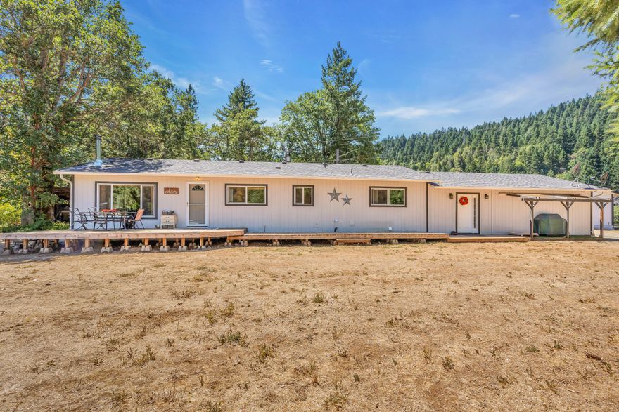 This stunningly renovated ranch-style home boasts 2,040 square feet of modern living space on 5.93 acres with the seasonal Thompson Creek. The spacious 4 bedroom, 2 bath floor plan is perfect for both relaxation and entertaining guests, with a large deck that seamlessly connects to the living space. 

The true heart of this home is the beautifully updated kitchen with granite counters, stainless steel appliances, and an open layout. Natural light floods the home, highlighting the tasteful upgrades that make this home a remarkable retreat.

This expansive property is a nature lover's paradise, complete with a fenced garden, hothouse, and large greenhouse, perfect for growing your own fresh produce. Additionally, the property boasts a large shop with air conditioning, ideal for any project or hobby, and RV hookups. 

Buyers are to perform their own due diligence into conditions and intended use of the property. Too many upgrades to list; see attached documents.