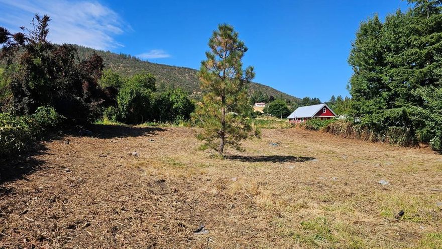 Prime .39-acre lot tucked 120' off Talent Ave, just 3.5 miles from Ashland Plaza.  This oversized parcel offers versatile build options under current city code: dream home with large shop, duplex, home with one or two ADUs, 4-6 unit cottage cluster, or potential lot split. TID water rights run through the property, adding charm and utility.  All services are at the lot's edge. Arguably the best build-ready site in Talent—private, flexible, and full of potential.  Partial owner carry available for qualified buyers with a proven local track record.