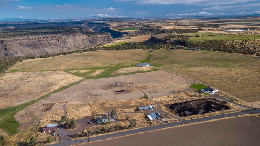 Almost 40 acres of spectacular views of the Cascade Mountains. Surrounded by beautiful farm ground the 3bd, 2bth stick built home was built in 2021. Located a good distance across the S. end of the property is a 3bd, 2bth doublewide home built in 1986. The riding arena is approx 250' by 155'. Next to the arena is a cute 4 stall horse barn with a tack room. On top of the barn is the property's solar system. A shed with additional stalls and turnouts is located to the north of the horse barn. The shop is approx 65x30 and has a meat processing room. Homes on Deschutes Valley Water from Opal Springs. 37 ac of N. unit irrigation rights makes this property highly productive for various crops or pasture for livestock. Most is under wheel line irrigation. A large irrigation pond that is stocked with bass adds to the aesthetic views.  Minutes to: Lake Billy Chinook 16, Madras 22, Redmond 25, Bend 50. 2nd home is an accessory farm dwelling. Buyer to do their own due diligence on conforming use.