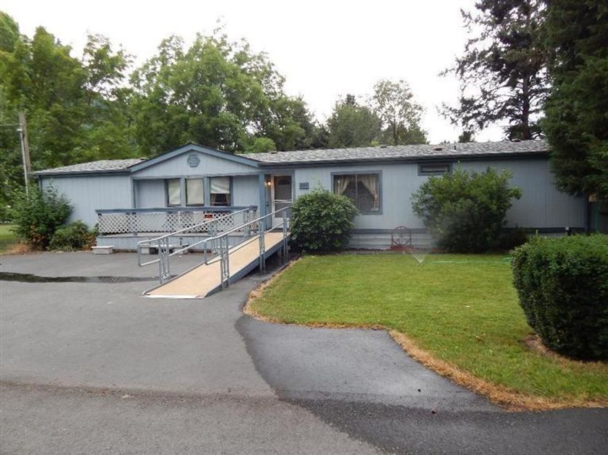 Manufactured home is clean and ready for you! Already set up for medical hardship!! If you have a family member who needs care and also some independence, this is your home sweet home. Home sits on 1/2 acre with ramp access. The original cottage is a possible caretaker's space with its own garage, yard and carport. Covered deck on the MH overlooks the grassy back yard and makes a pleasant place to while away the hot afternoons. The location feels country private yet you are only minutes to town.
