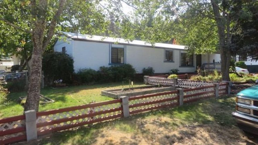 Cul-de-sac location and large, lovely, yard with mature hardwood trees and flowers! Quiet 55 park feels like it is out in the country yet located in the city limits of the quaint town of Rogue River; minutes to Grants Pass. Owner has upgraded home with new flooring of wood laminate and vinyl. Cozy and just big enough.