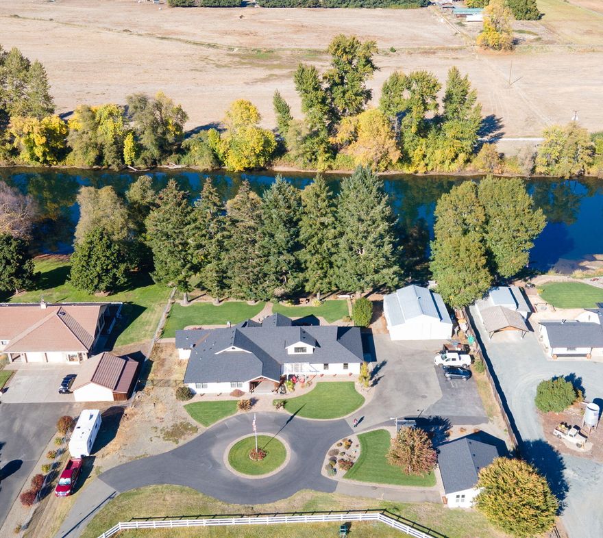 Exceptional Riverside Estate: The 3,826 sq ft residence, originally built in the 1970s, was meticulously reimagined and taken down to the studs for a full-scale renovation in 2020. Every element was carefully considered, resulting in a sophisticated blend of timeless elegance and modern luxury. Impeccably executed with premium finishes throughout, this home leaves nothing to be desired. Offering 5 bedrooms and 5 full baths (2 in the main suite), the home is accompanied by a charming 700 sq ft guest house. The property is ideal for horse lovers: featuring an 80' x 130' arena, a barn with 6 stalls and 24' turnouts, plus feed and tack rooms. Set along the banks of the Rogue River, the estate enjoys private river access.  The grounds are equally remarkable, with mountain and river views, a gated and paved driveway, and serene outdoor living spaces for entertaining and relaxation. The generous shop provides room for storage, or creative pursuits. This is more than a home - it's a lifestyle