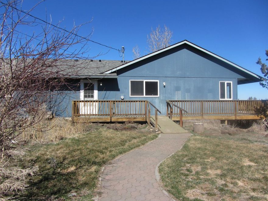 NOTE: All highest & best offers must be submitted by 4/2/2020.     Single-level 4 bedroom, 3 bath home on 5 acres! Fairly level fenced, ready for animals, provides extra storage buildings if needed. Served by Avion Water, irrigation water, pond, paved road, close to schools, town, and convenient to Bend or Sisters. Enjoy the country lifestyle in this beautiful neighborhood. Detached finished double garage included is well-lit, for your vehicles or shop space. Island kitchen with corner windows, adjoining large dining area, vaulted living space. Nice separation of bedrooms, two master bedrooms. One large master suite is suitable for guest or mother-in-law quarters, features adjoining bath, walk-in closet, and sliding glass door. The other three bedrooms are located on opposite end of home. Separate utility room makes a nice back entry. Decking off the kitchen-living area is perfect for entertaining and overlooks the front pasture. Grab this and spend the summer making